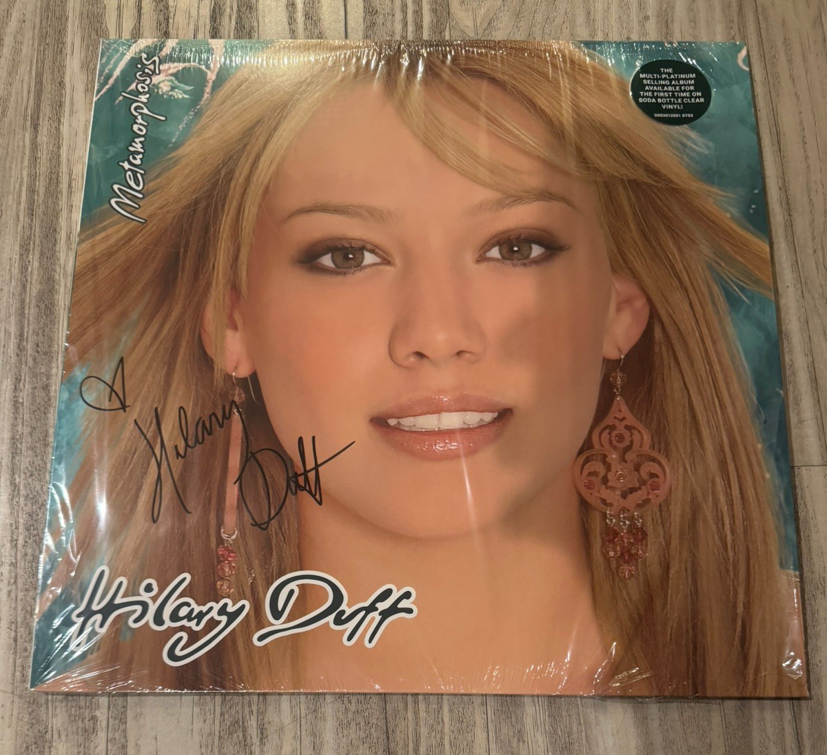 AUTOGRAPHED Metamorphosis (Coke Bottle Clear Vinyl LP) – SIGNED by Hilary Duff