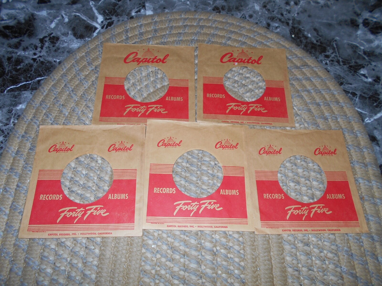 45 COMPANY SLEEVES. LOT OF FIVE CAPITOL. FORTY FIVE TEXT, 1950’S.