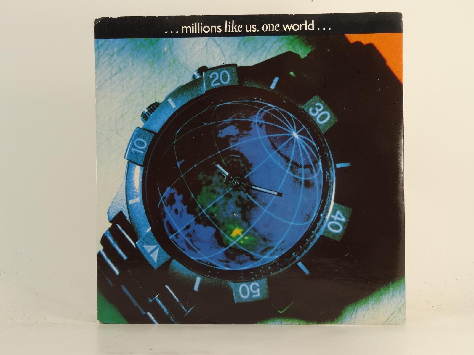 MILLIONS LIKE US ONE WORLD (77) 3 Track 7″ Single including Plain Paper Sleeve C